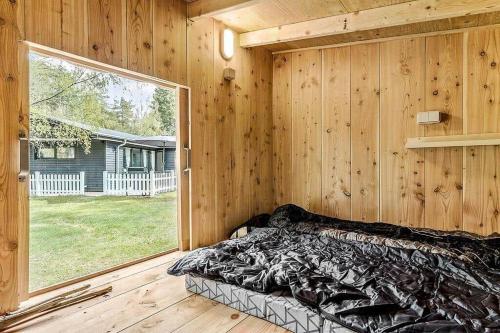 a bedroom with a bed and a large window at 84100-Ebeltoft-Magevej-4 in Ebeltoft