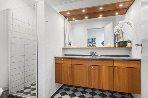 a bathroom with a sink and a mirror at 8250-Ega-Strandvangsvej-52 in Egå