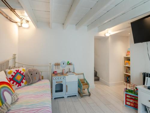 a childs room with a couch and a stove at 4 Smiddy Hill in Pickering