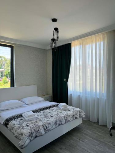 a bedroom with a bed and a large window at Sunset paradise in Ureki