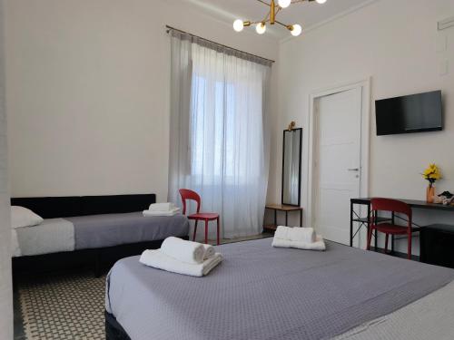 a living room with two beds and a table at Palazzo San Giorgio 1924 in Scilla