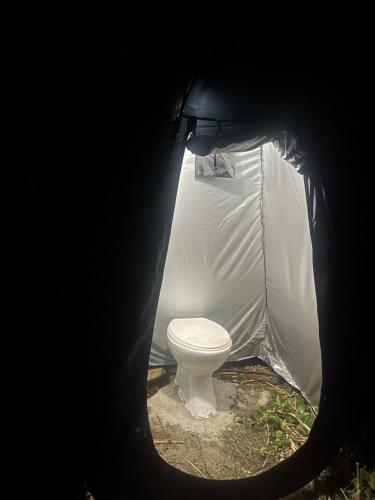a toilet in a tent with a toilet inside at StNicholas Ranch Corfu Wild Camping 2 in Benitses