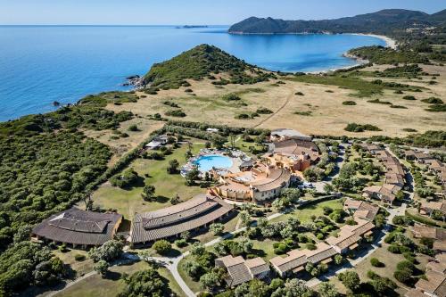 an aerial view of a mansion next to the water at Sant'Elmo Beach Hotel in Castiadas