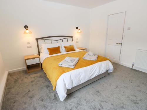 a bedroom with a large bed with two towels on it at Saltaire House in Saltaire