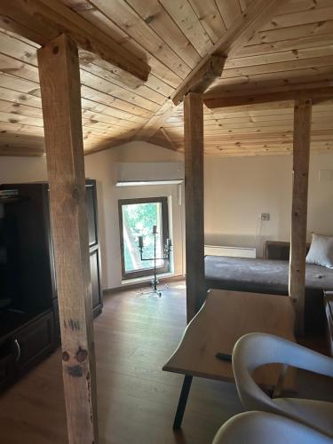 a room with a loft with a bed and a table at Къща за гости Гергана in Troyan