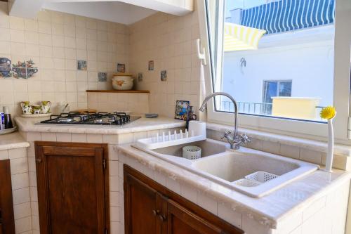 a kitchen with a sink and a stove at Casa Ginevra Capri in Capri