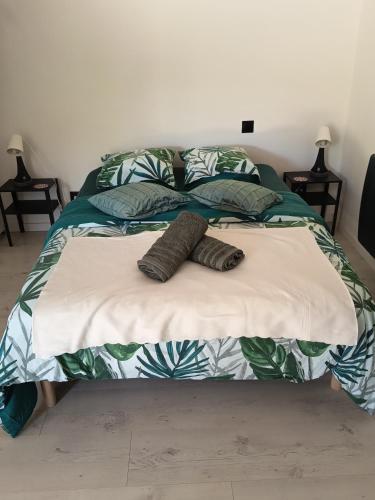 a bed with two pillows on top of it at Peaceful apartment in Vierzon
