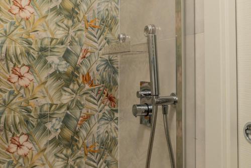 a shower in a bathroom with a floral wallpaper at La Casa al Centro in Policoro