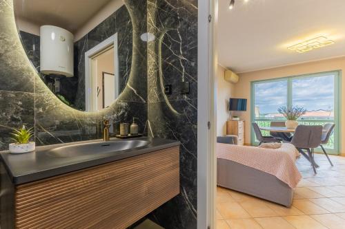 a bathroom with a sink and a mirror at Gina Gedici Resort in Gedići