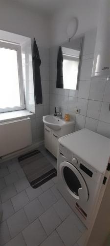 a white bathroom with a washing machine in it at Ela Gar 3 WG Zimmer in Garsten