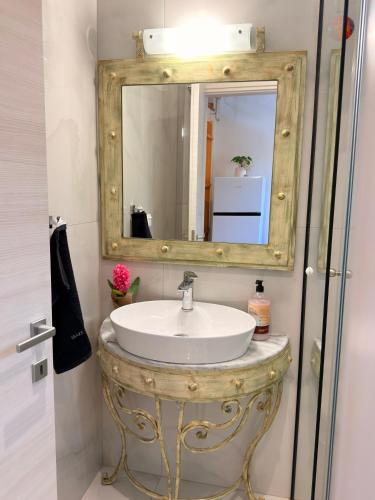 a bathroom with a sink and a mirror at Thea Suite & Loft in Kavála