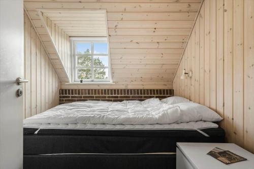 a large bed in a room with a window at 146-Ringkobing-Hvidbjergvej-23 in Søndervig