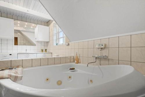 a large white bath tub in a bathroom at 146-Ringkobing-Hvidbjergvej-23 in Søndervig