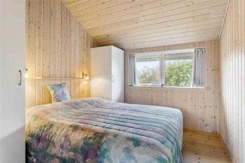 a bedroom with a large bed in a small room at LF403-Hurup-Thy-Klydevej-6 in Sindrup