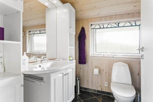 a bathroom with a toilet and a sink at LF403-Hurup-Thy-Klydevej-6 in Sindrup