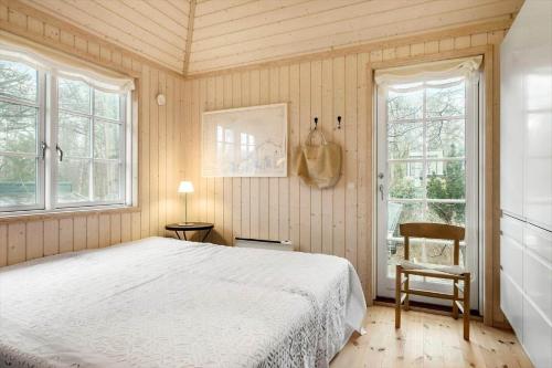 a bedroom with a white bed and two windows at 1523-Vejby-Store-Orebjergvej-53-B in Vejby