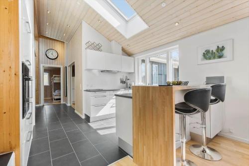a kitchen with white cabinets and a skylight at 8302-Kolind-Falkevej-34 in Kolind