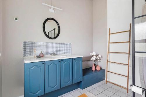 a blue bathroom with a sink and a mirror at LF15081-Farso-Illeris-121 in Farsø