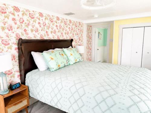 a bedroom with a bed with floral wallpaper at Whimsea Cottage in Twillingate