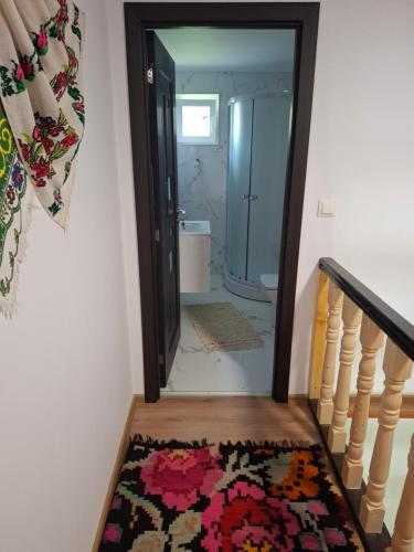 a hallway with a stairway with a rug at Casa cu Poveste in Dorna Arini