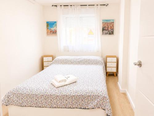 a bedroom with two beds with white towels on them at Aroma D Valencia Luxury and Designer Apartment in Valencia
