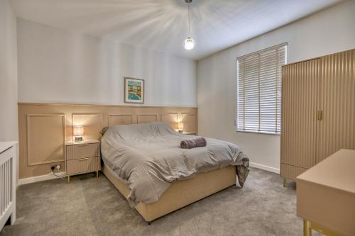 a bedroom with a bed and two night stands and a window at Finest Retreats - Dockyard House in Pembroke Dock