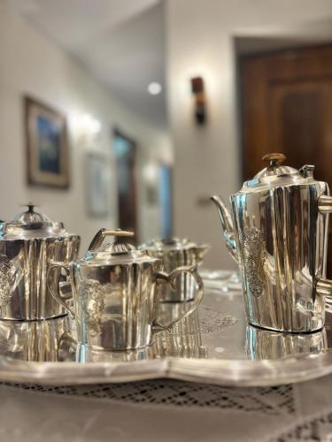 a group of silver tea pots on a tray at Relais Casa Spanu in Dorgali