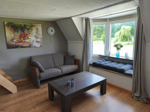 a living room with a couch and a window at The Colored Butterfly in Månstad
