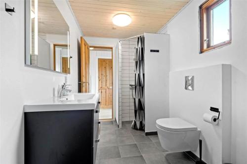 a bathroom with a sink and a toilet at C11213-Hemmet-Alpehuen-4 in Hemmet