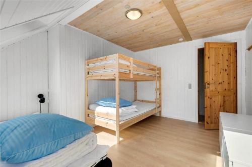 a bedroom with two bunk beds and a wooden ceiling at C11213-Hemmet-Alpehuen-4 in Hemmet