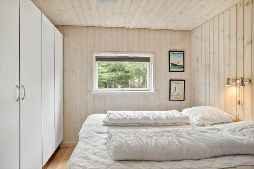 a bedroom with two beds and a window at M191-Vaeggerlose-Baeverstien-46 in Bøtø By