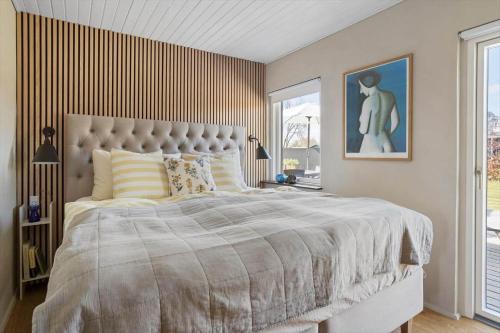 a bedroom with a large bed and a large window at 30111-Odder-Lundgaardsvej-7 in Odder