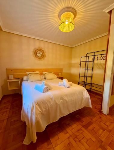 a bedroom with a bed with two towels on it at La casina de isa in Aller