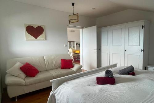 a living room with a bed and a couch at Fernblick Appartement Simonhöhe in Zirkitz