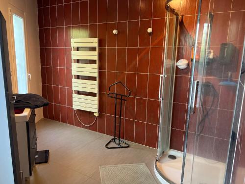 a bathroom with a shower with red tile at Villa Design le Crès in Le Crès