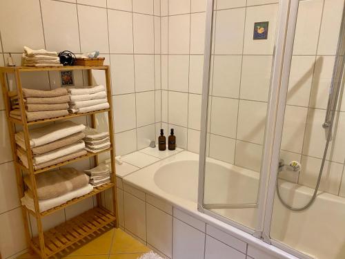 a bathroom with a shower and a tub with towels at Apartment with Terrace & Garden View in Zwiesel