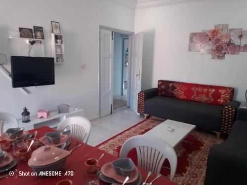 a living room with a couch and a table at appart CRISTIANA 3 Midoun in Midoun