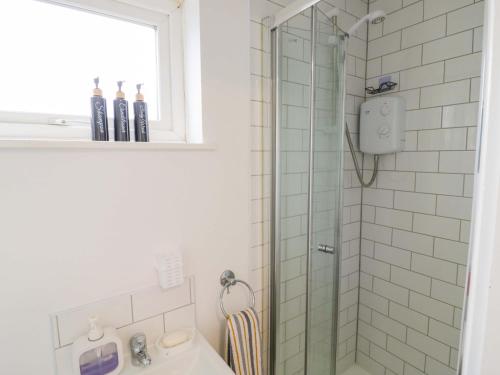 a bathroom with a shower and a sink at Lodge Park in Corby