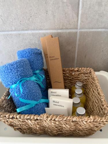 a basket with towels and other items in a bathroom at Angelos Studios in Ilia