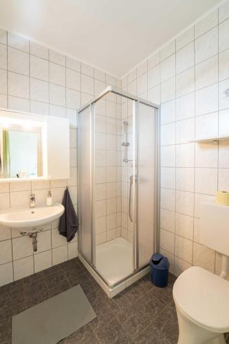 a bathroom with a shower and a toilet and a sink at Gästehaus Elfriede in Mörbisch am See