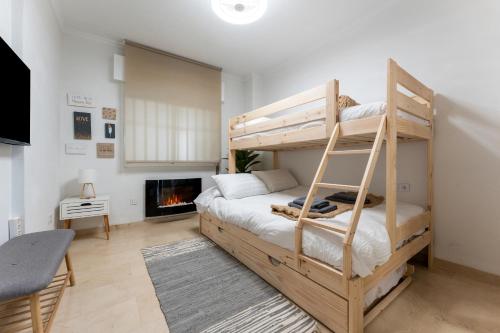 a bedroom with a bunk bed and a fireplace at El Rey in Fuengirola