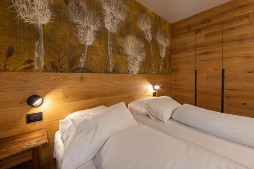 a bedroom with a bed with a painting on the wall at Maison Luboz - Courmayeur in Courmayeur