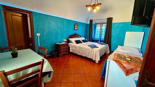 a bedroom with two beds and blue walls at Le Vie del Castello in Francavilla Bisio