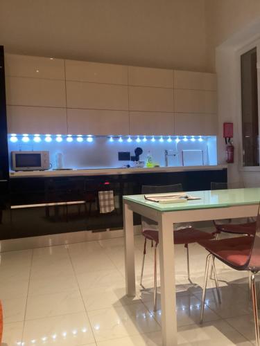 a kitchen with a table and a counter with blue lights at Apartment best Harbour view in Valletta