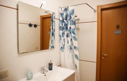a bathroom with a sink and a mirror at Capalbio Relax - Super terrazza in Capalbio