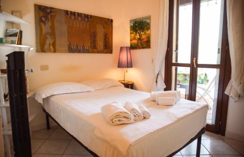 a bedroom with a bed with towels on it at Capalbio Relax - Super terrazza in Capalbio