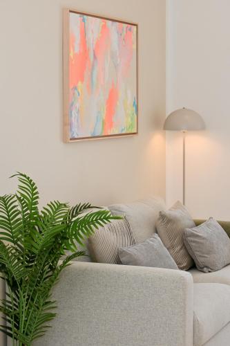 a living room with a white couch and a plant at Casa Dalmatia in Krvavica