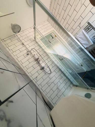 a bathroom with a shower and a sink at Urban Stay Apartment in Aylsham