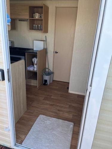a small room with a door and a broom at 7 Jay Valley in Bridlington
