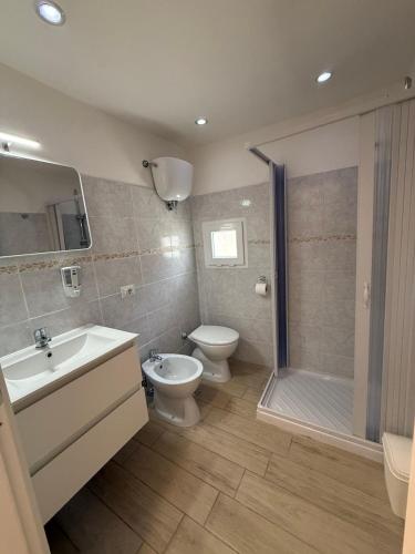 a bathroom with a toilet and a sink and a shower at Da Silvi Apartment in Terracina